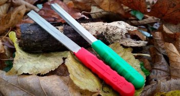 Hook sharpening kit contents on bed of leaves