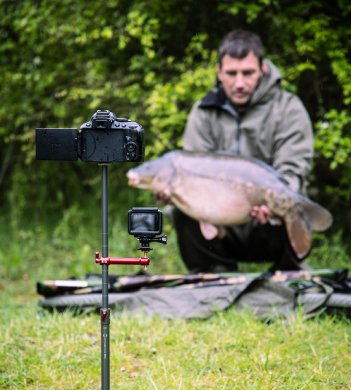 Self take photography of angler with carp